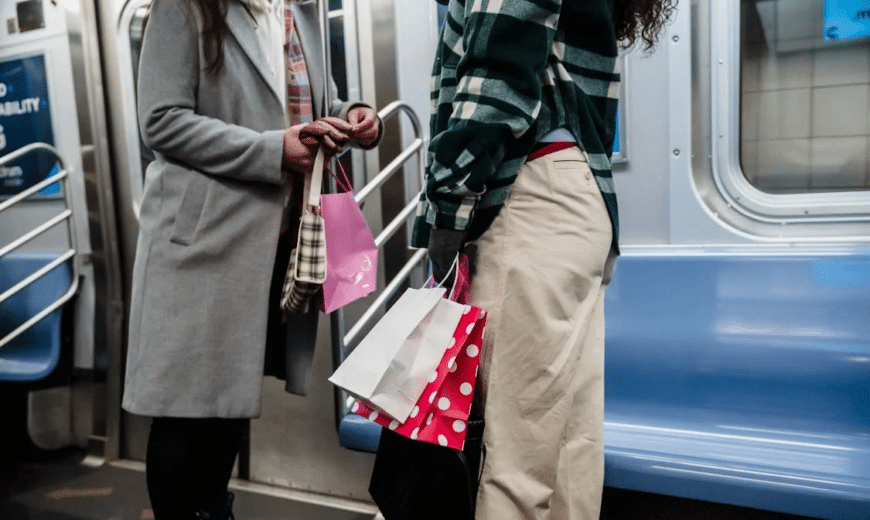 Two people riding on the subway