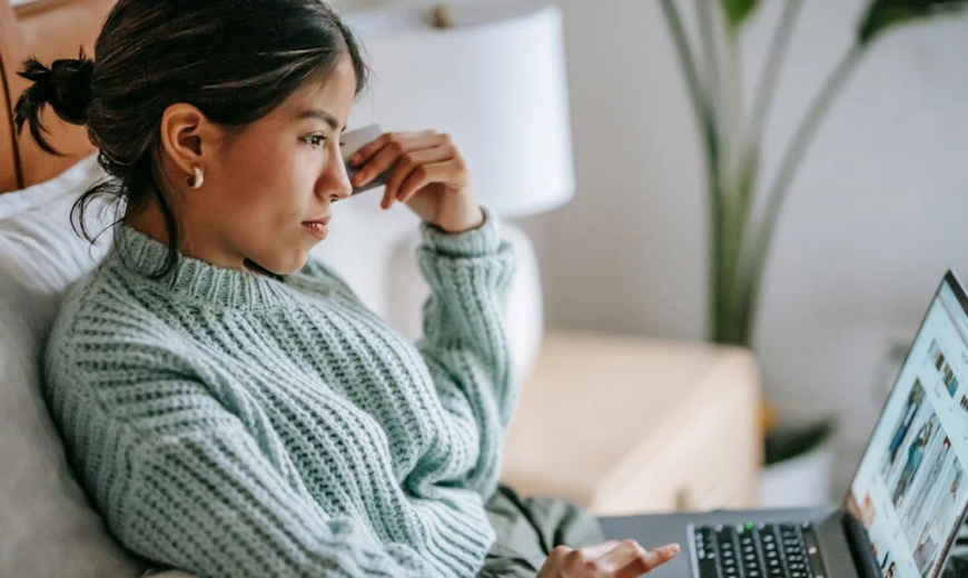 A woman shopping on a laptop