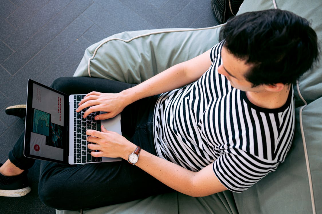 A person typing a laptop