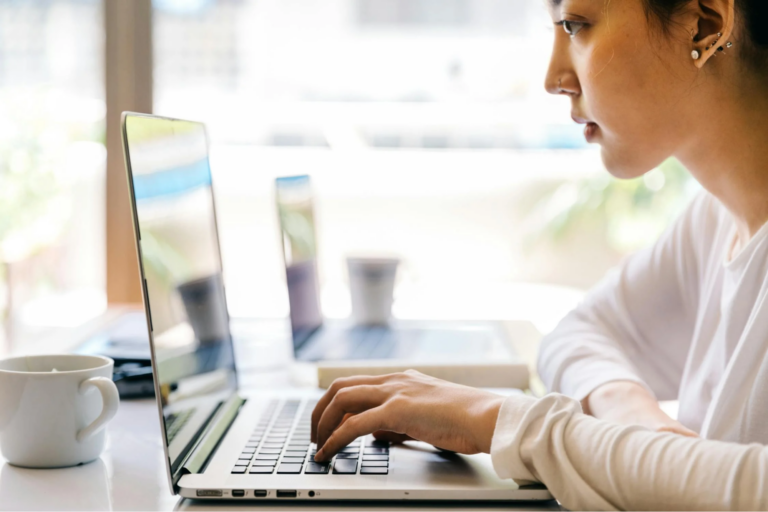 A woman typing on a keyboard