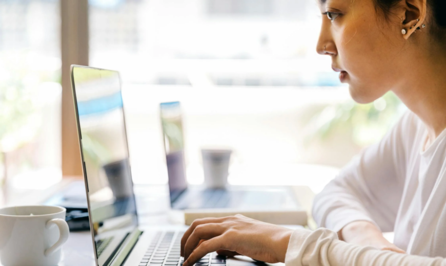 A woman typing on a keyboard