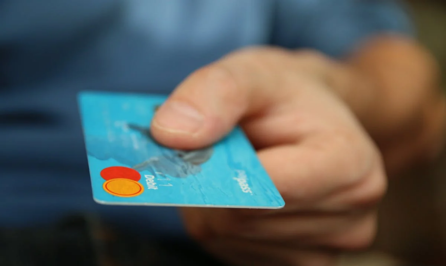 A person holding a credit card